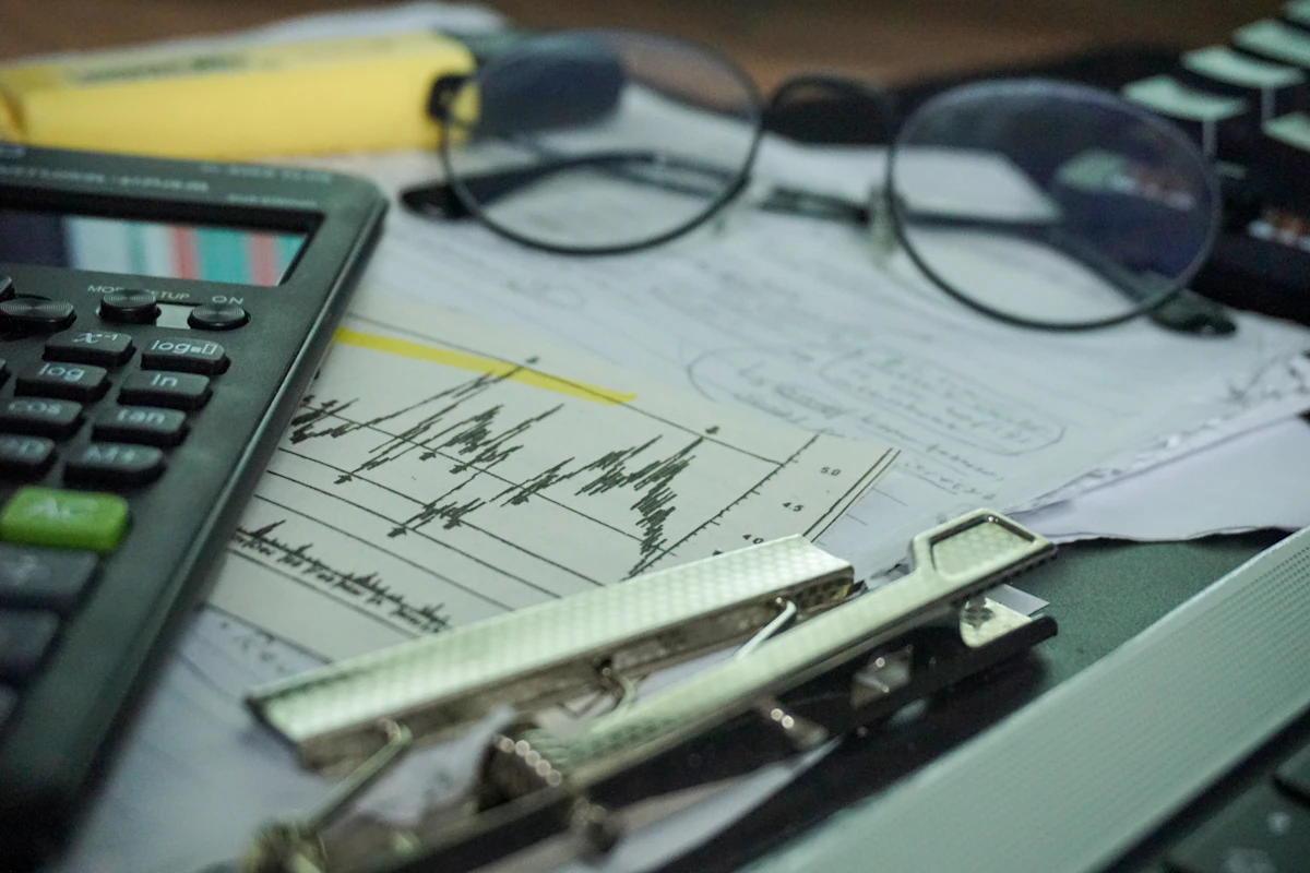 Calculator and printed reports on an office desk