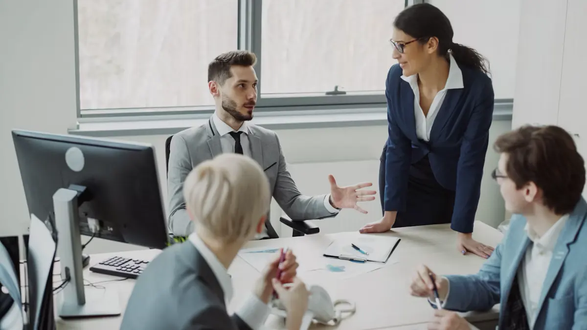 Office colleagues discussing work together.