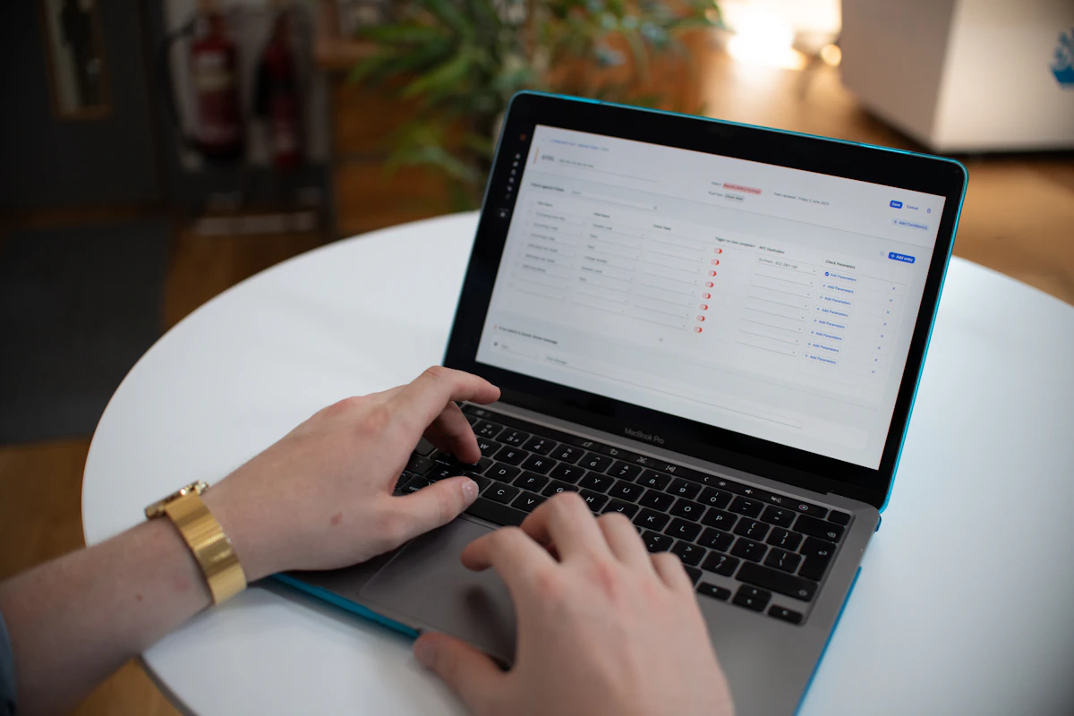 Hands working with a spreadsheet on a laptop; illustrative stock photo