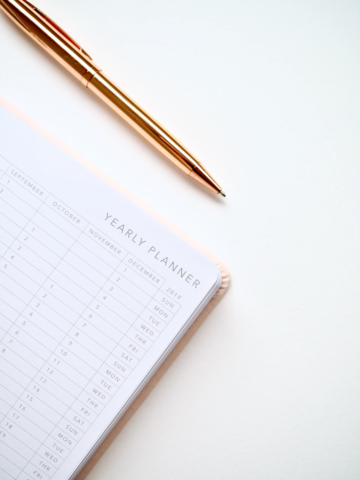 Open monthly planner with a pen