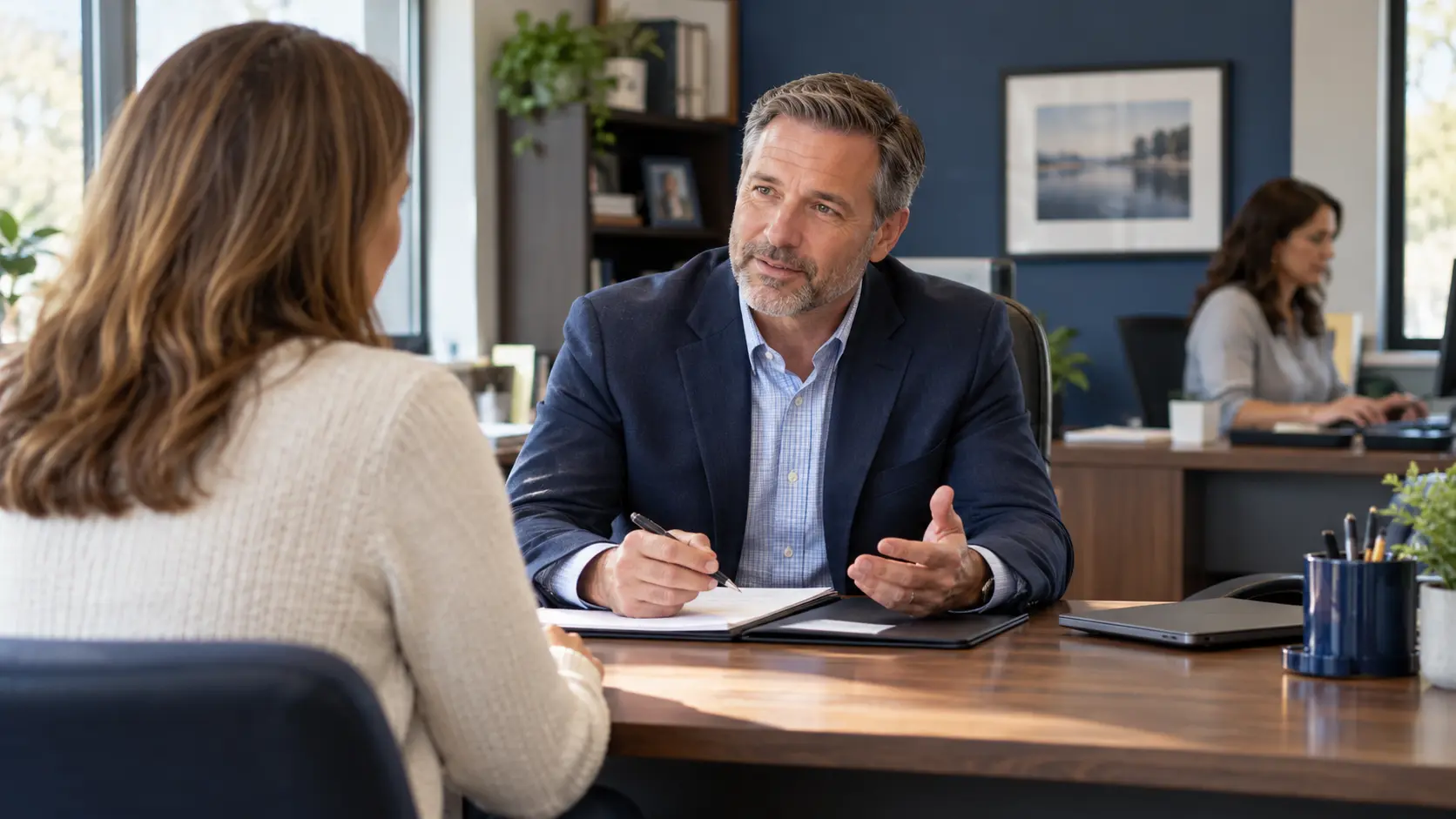 An insurance agency team helping clients in a small office.